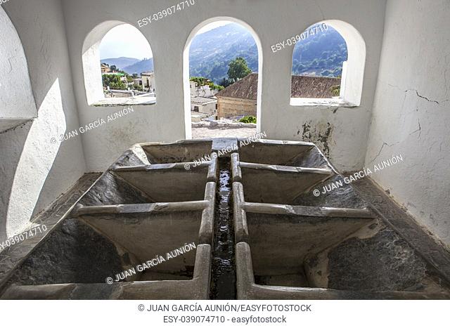 Roofed hand laundry building on quiet pretty town of Alpujarras, Granada, Spain