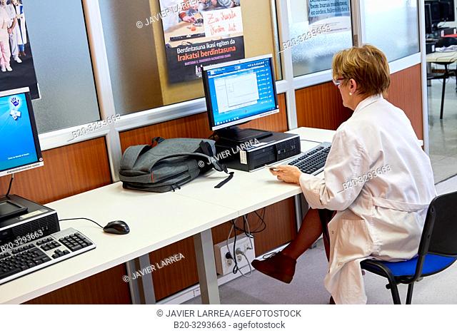 Doctor consulting on a computer, Library, Hospital Donostia, San Sebastian, Gipuzkoa, Basque Country, Spain
