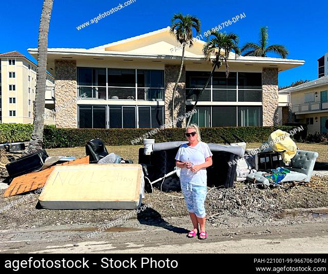 HANDOUT - 30 September 2022, US, Naples: Sheri Naegele stands in front of her vacation home on posh Gulf Shore Boulevard, just off the beach, on Sept