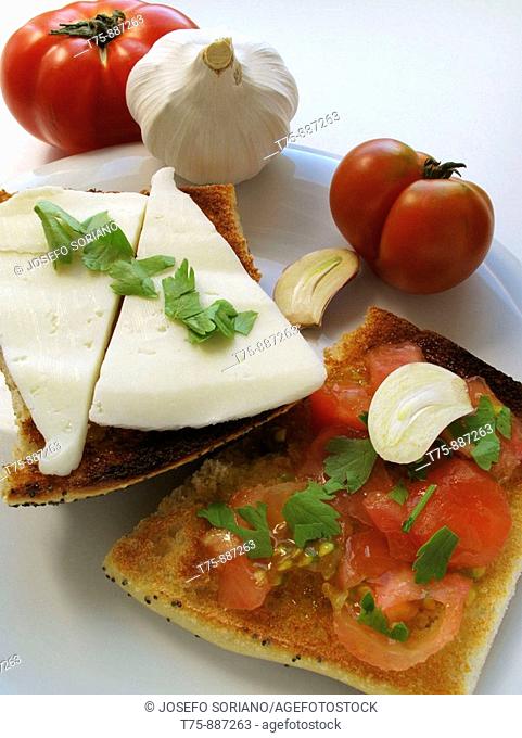 Toast with garlic, oil, tomato, cheese and parsley