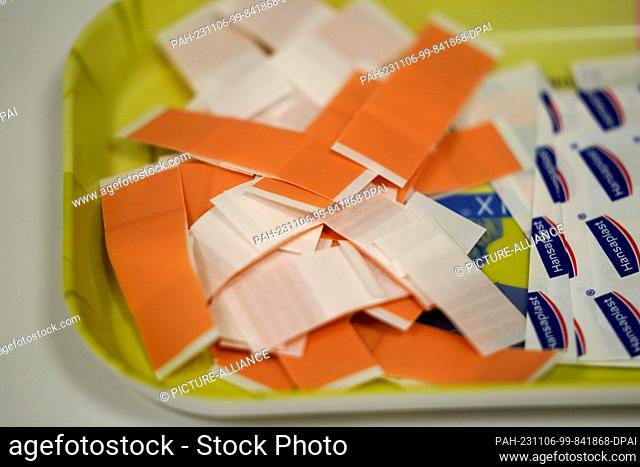 06 November 2023, Hamburg: Plasters lie on a table in the vaccination center at the Institute for Hygiene and Health. Social welfare authorities and doctors'...