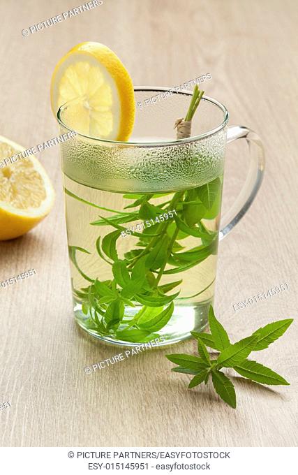 Glass with lemon verbena tea and lemon