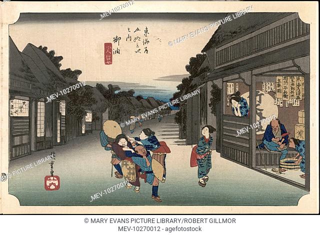 36 Goyu - Main street of the village at nightfall and female touts dragging travellers into the teahouse on the right, where one is already resting