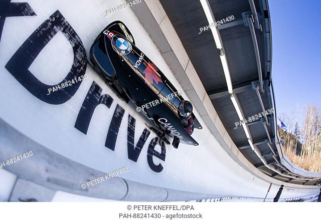 Bobsleigh athletes Chris Spring and Alexander Kopacs from Canada in the 3rd lap going through the echo curve in Schoenau am Koenigssee in Germany