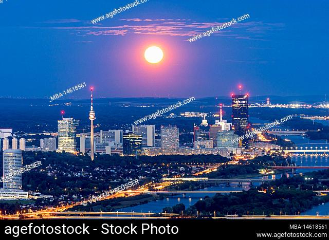 Vienna, full moon rise, super moon, view from mountain Leopoldsberg to Donaucity and river Donau (Danube), Neue Donau (New Danube), island Donauinsel