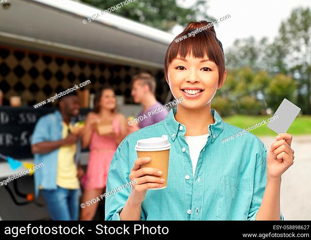 happy asian woman drinking coffee over food truck