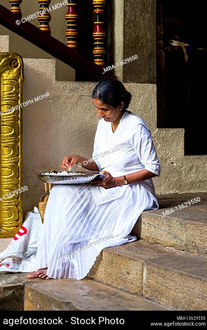 Sri Lanka, Kandy, Sri Dalada Maligawa, the Temple of the Sacred Tooth, elderly woman, rice bowl