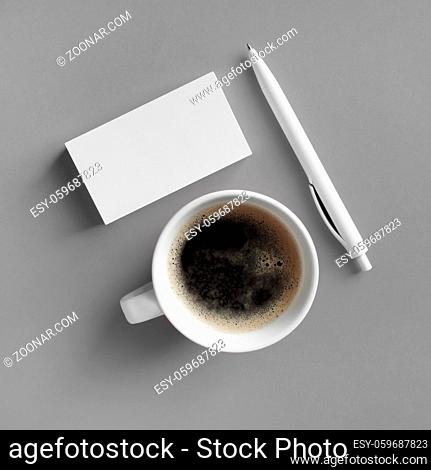 Blank stationery and coffee cup on gray background. Responsive design mockup. Flat lay