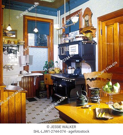 KITCHENS - View to restored 1916 Glenwood cast iron stove in remodeled Victorian kitchen, green tin molding, lots of authentic antiques and accessories, molding