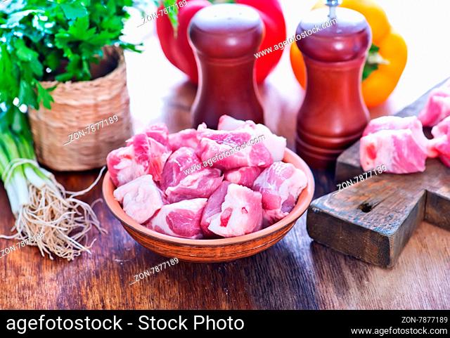 raw meat and fresh vegetables on a table