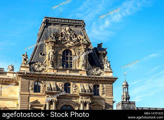 Detail of the left wing facade of Louvre Palace on a sunny summer day in Paris, France