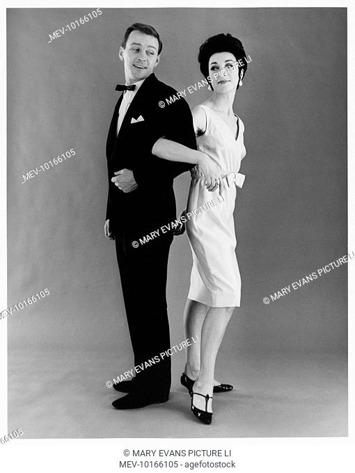 A couple in formal evening dress pose for the camera