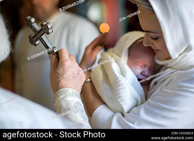 Belarus, Gomel, January 19, 2019. Prudkovsky church.The baptism of a child.The mother holds the child on her hands during the rite of baptism