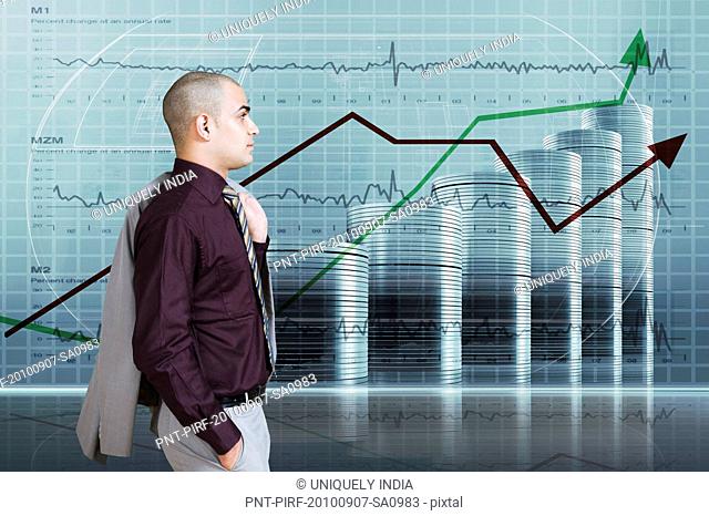 Businessman looking at a line graph