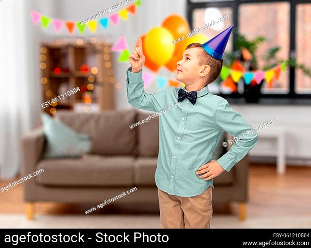 little boy pointing finger up on birthday party