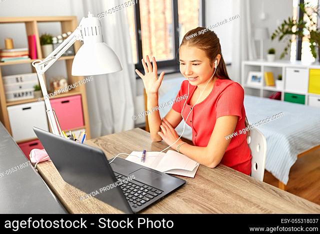 student girl with laptop having video call at home