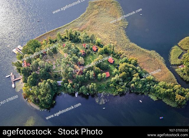 Island on Narie Lake located in Ilawa Lakeland region, view from Kretowiny village, Ostroda County, Warmia and Mazury province of Poland