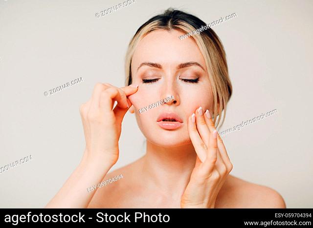 Woman doing facial gymnastics self yoga massage and tighten up face skin