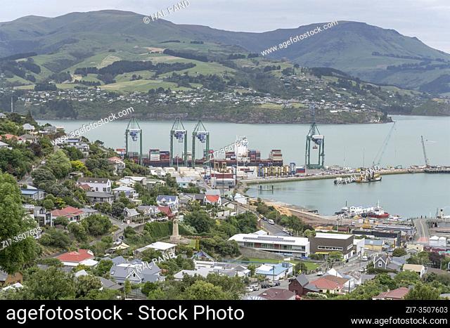 LYTTLETON, NEW ZEALAND - December 02 2019: aerial cityscape with cranes and cargo on harbor quays, shot in bright cloudy light on december 02 2019 at Lyttleton