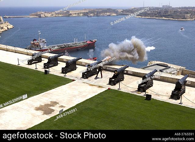The Saluting Battery. The Malta Noon Day Cannon Gun Firing in Valletta, Malta. The Malta Noon Day Gun, originally started in the year 1566