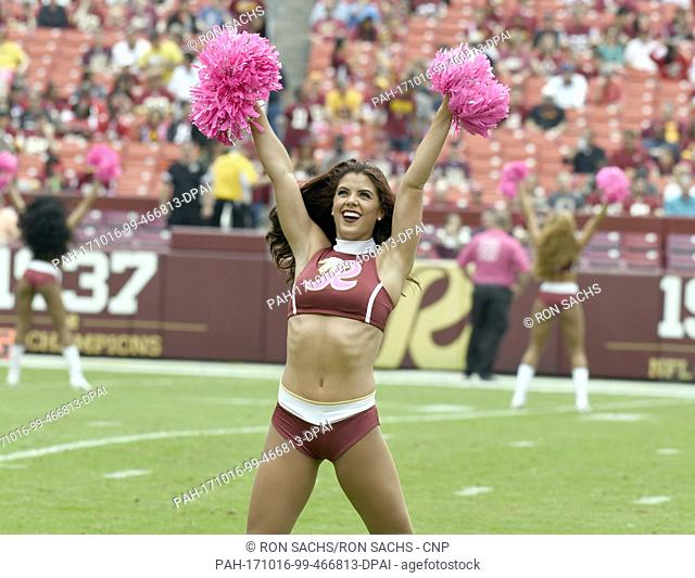 A Washington Redskins cheerleader sports pink pom-poms and a pink ""R"" on her uniform as she performs prior to the game against the San Francisco 49ers at...