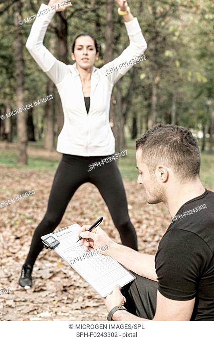 Woman working out with personal trainer