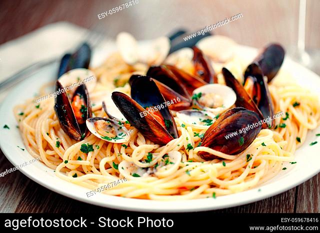 Spaghetti with seafood and herbs on a plate