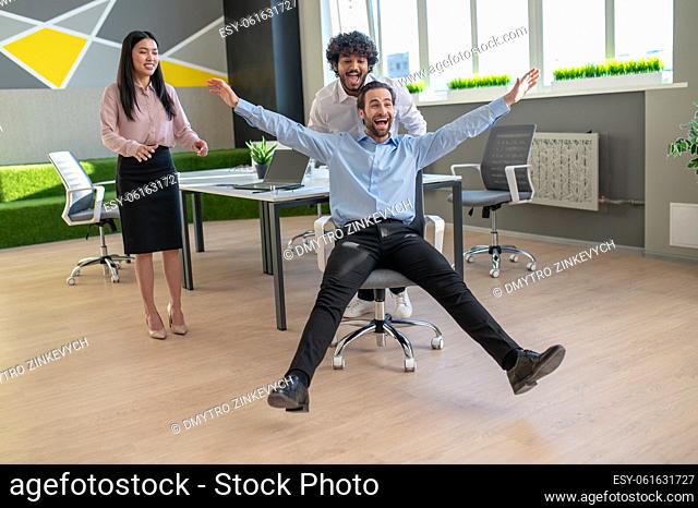 Have fun. Young colleagues having fun in the office after work