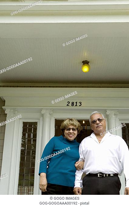 Senior couple standing, low angle view