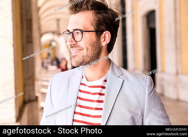 Piortrait of smiling young man in the city, Lisbon, Portugal