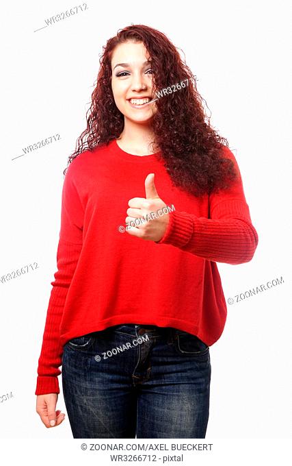 happy young woman with a big toothy smile making thumbs up hand sign