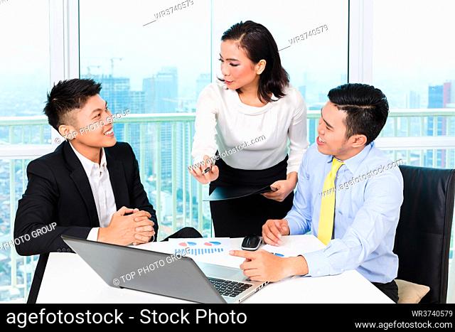 Asian banker counseling client finance investment in bank office