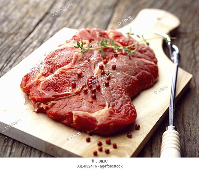 Raw beef ribsteak on chopping board