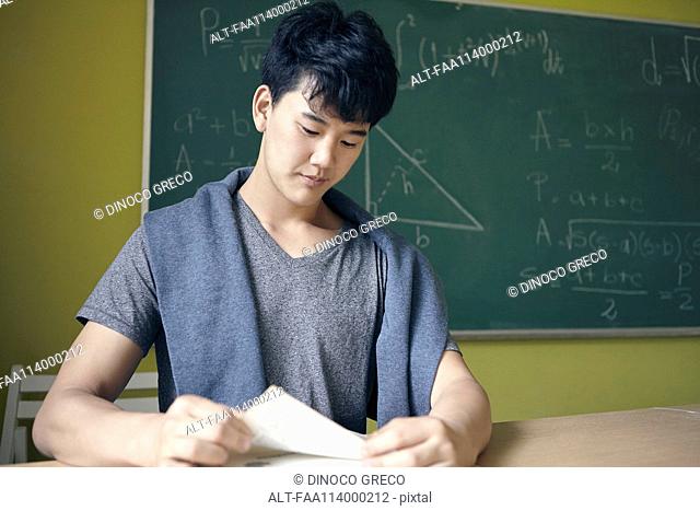 Young man studying in math class