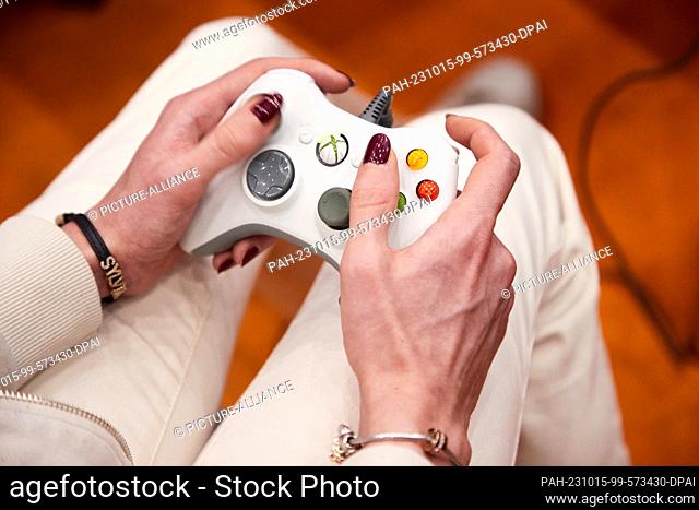 15 October 2023, Hamburg: A visitor plays with a controller at the gaming fair ""Polaris Convention"". Around 200 exhibitors from and for the gaming world are...