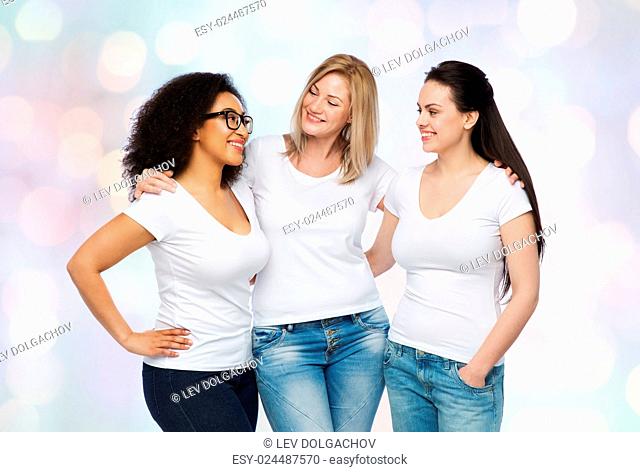 friendship, diverse, body positive, communication and people concept - group of happy different size women in white t-shirts hugging and talking over holidays...