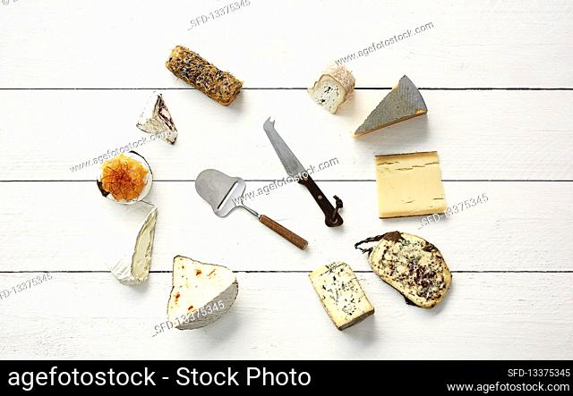 Various cheeses with a slicer and a cheese knife