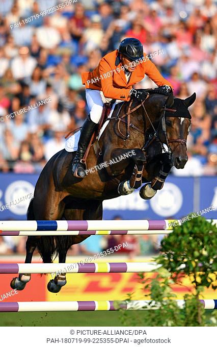 19 July 2018, Germany, Aachen: CHIO, Equestrian sports, jumping. Dutch rider Marc Houtzager on Baccarat jumping over an obstacle during the Nations Cup