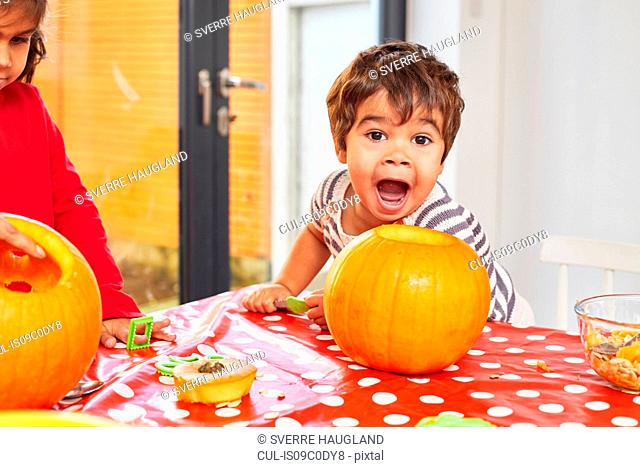 Boy making funny face in kitchen