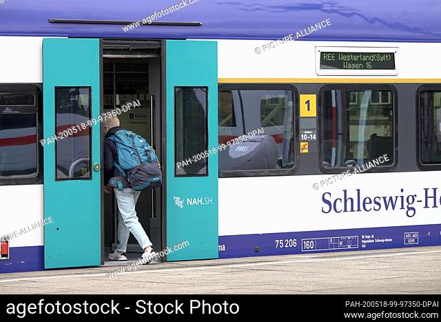 15 May 2020, Hamburg: One passenger boards a regional express (RE 6) of the Deutsche Bahn to Westerland (Sylt), which is ready for departure at Altona station