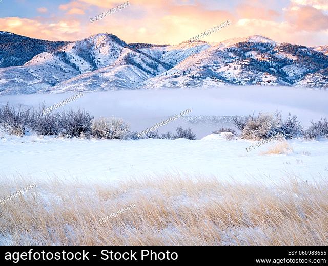 scenery of a mountain lake and valley covered by fog at winter sunrise - Horsetooth Reservoir at foothills of Rocky Mountains in Colorado
