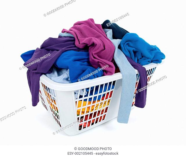 Bright clothes in laundry basket. Blue, indigo, purple