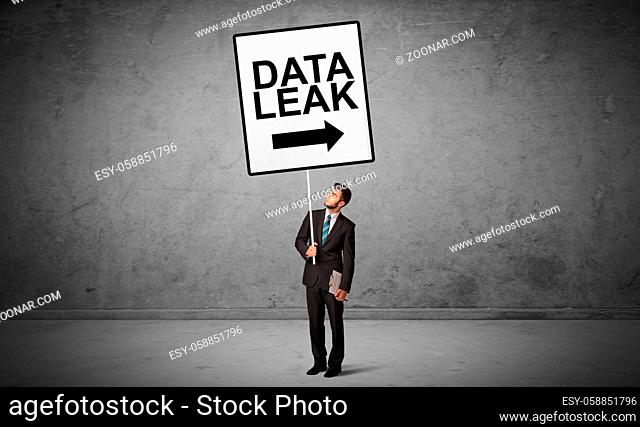 business person holding a traffic sign with DATA LEAK inscription, new idea concept