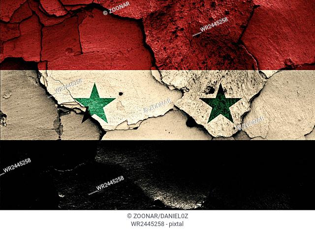 flag of Syria painted on cracked wall