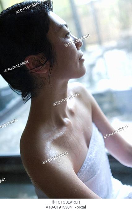 Woman in a hot tub, side view, Japan