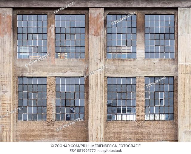 weathered industrial building detail with old rundown windows