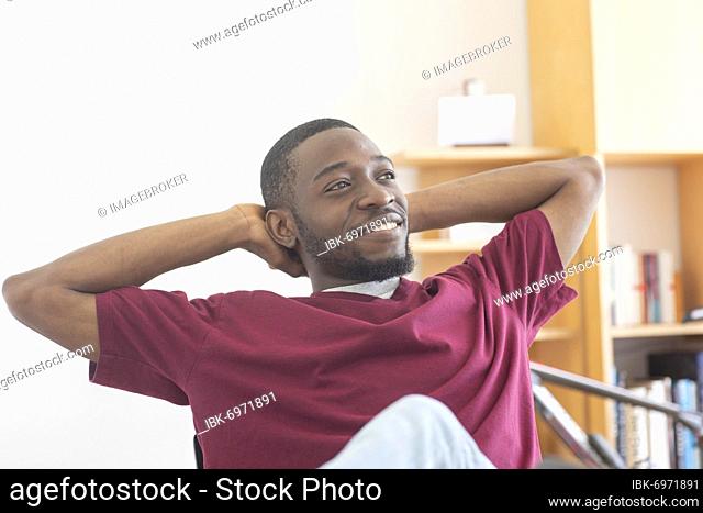 Young black man reconsiders a vision or innovation in the office, Freiburg, Baden-Württemberg, Germany, Europe