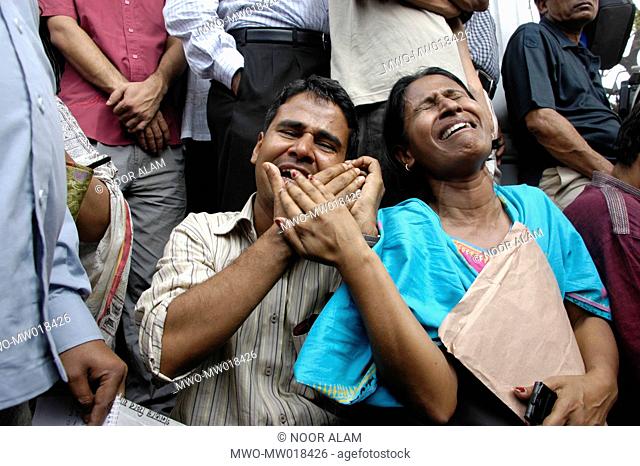 The wailing relatives of a lost army personnel at the gate of BDR Headquarters, in Pilkhana, Bangladesh Many of the military officers are still missing after...