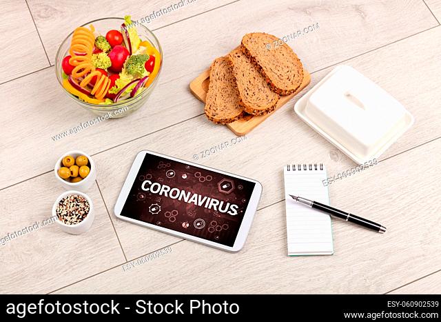 Healthy Tablet Pc compostion with CORONAVIRUS inscription, immune system boost concept