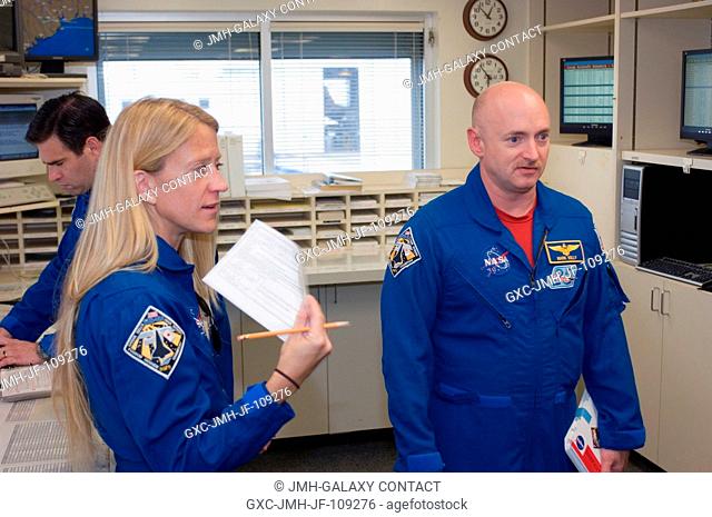 Astronauts Mark Kelly (right), STS-124 commander; Karen Nyberg and Greg Chamitoff, both mission specialists, go over their flight plans in the check-out...